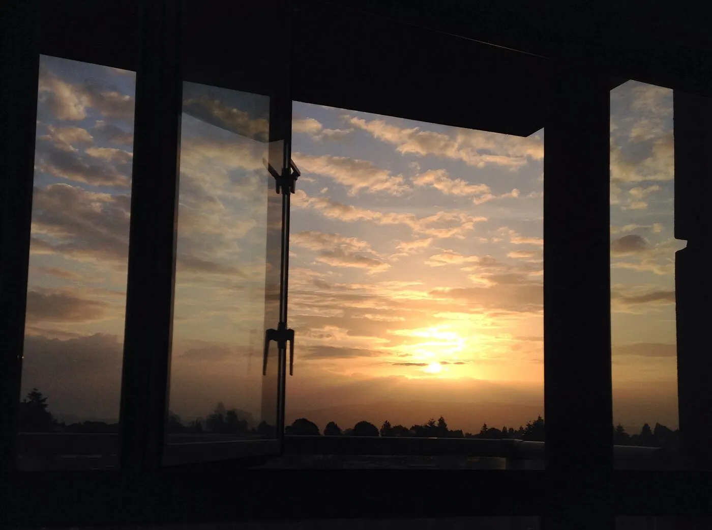 Morning sky at sunrise seen through an open window