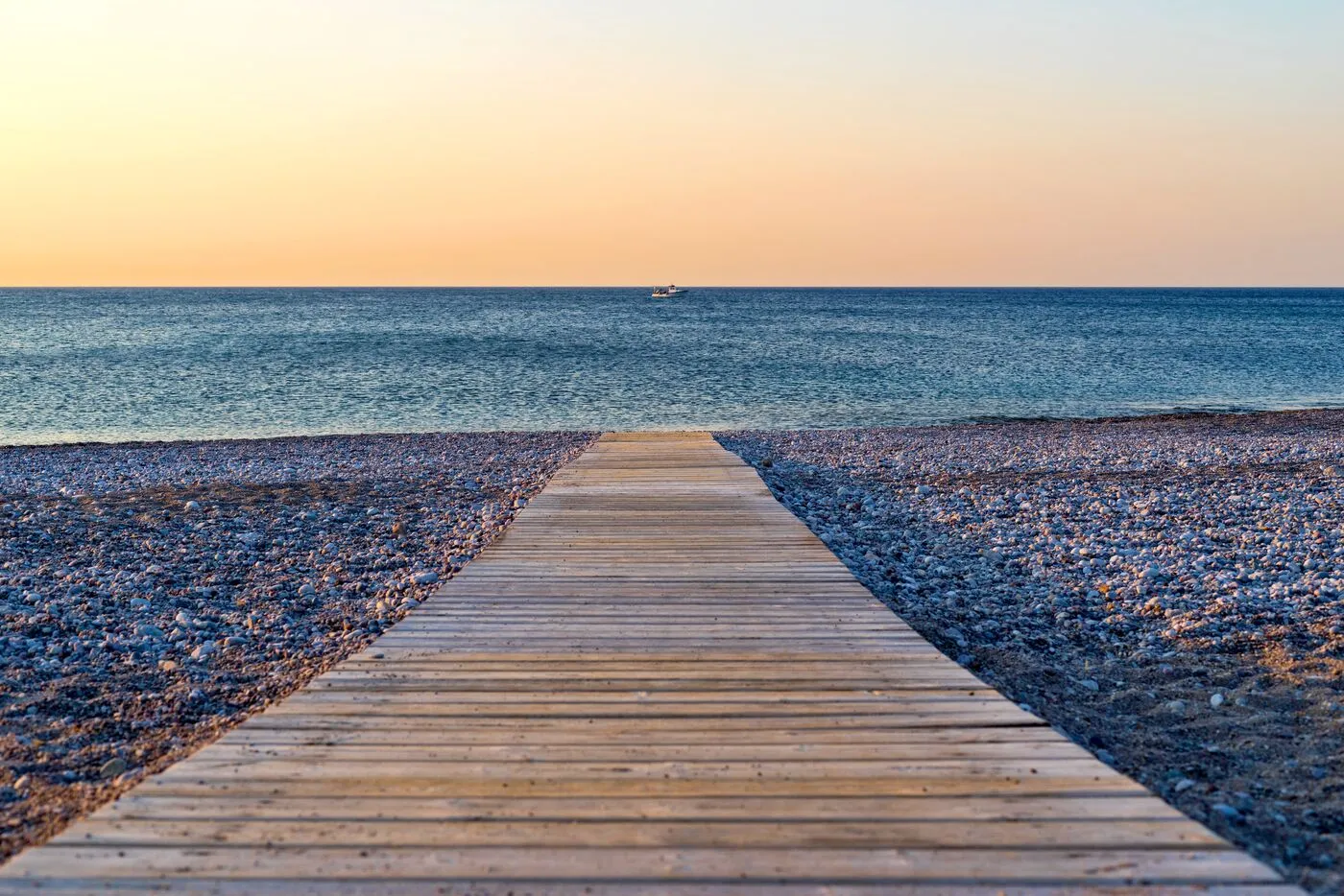 A path through dunes toward the sea at dawn